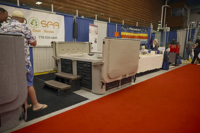 Full view of the Eco Spa E3 hot tub with its hard cover and steps